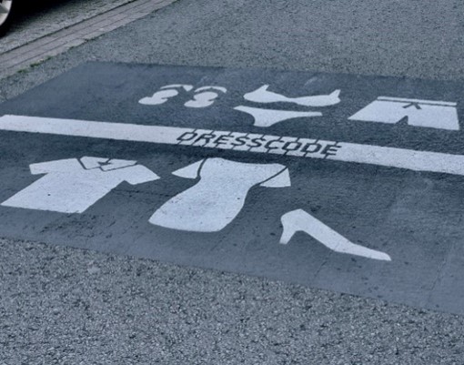Road with dress code painted in white.